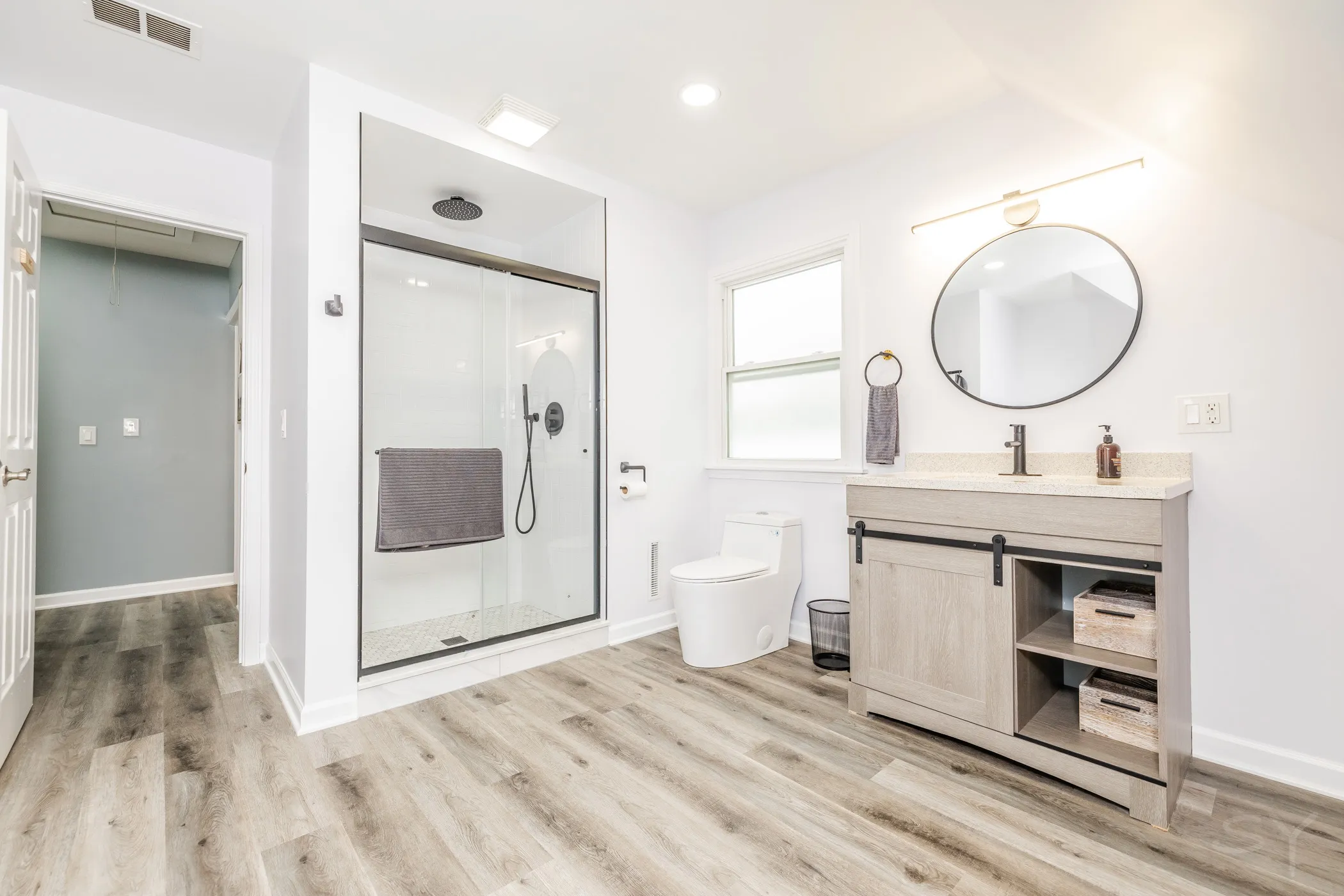 Bathroom with a rustic gray vanity and walk-in glass shower