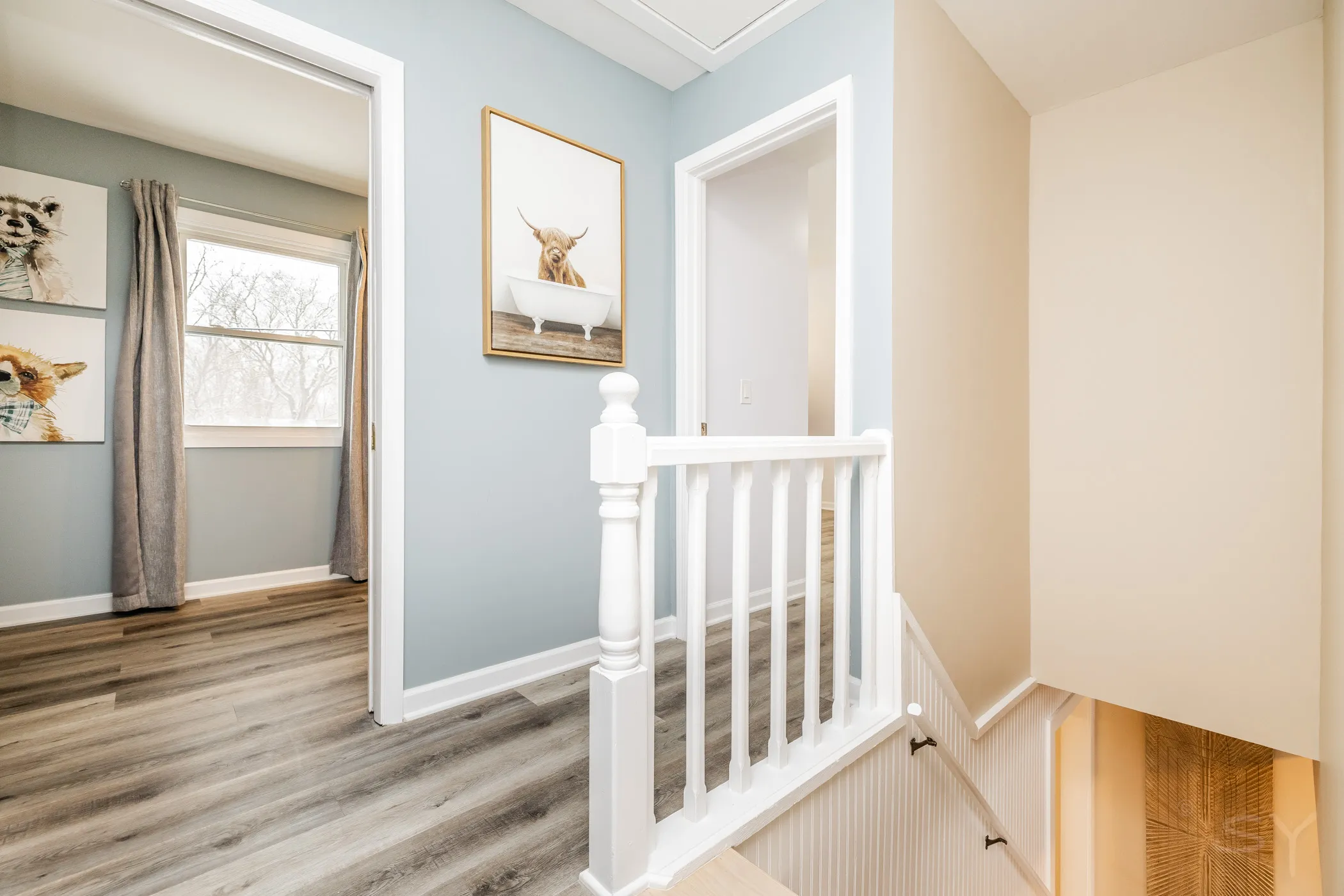 Upstairs landing with a stair railing and animal art