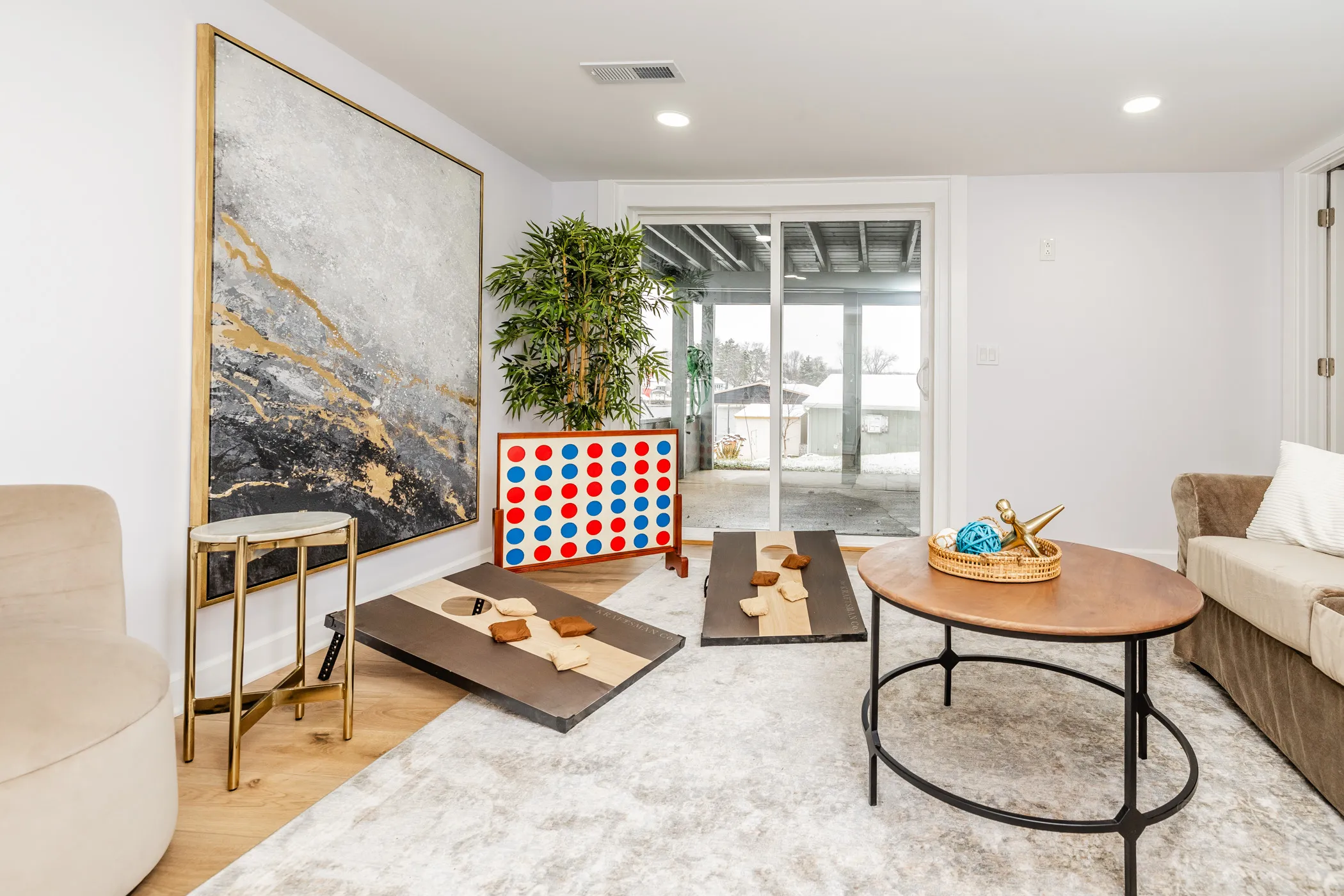Game room with giant Connect 4 and cornhole boards