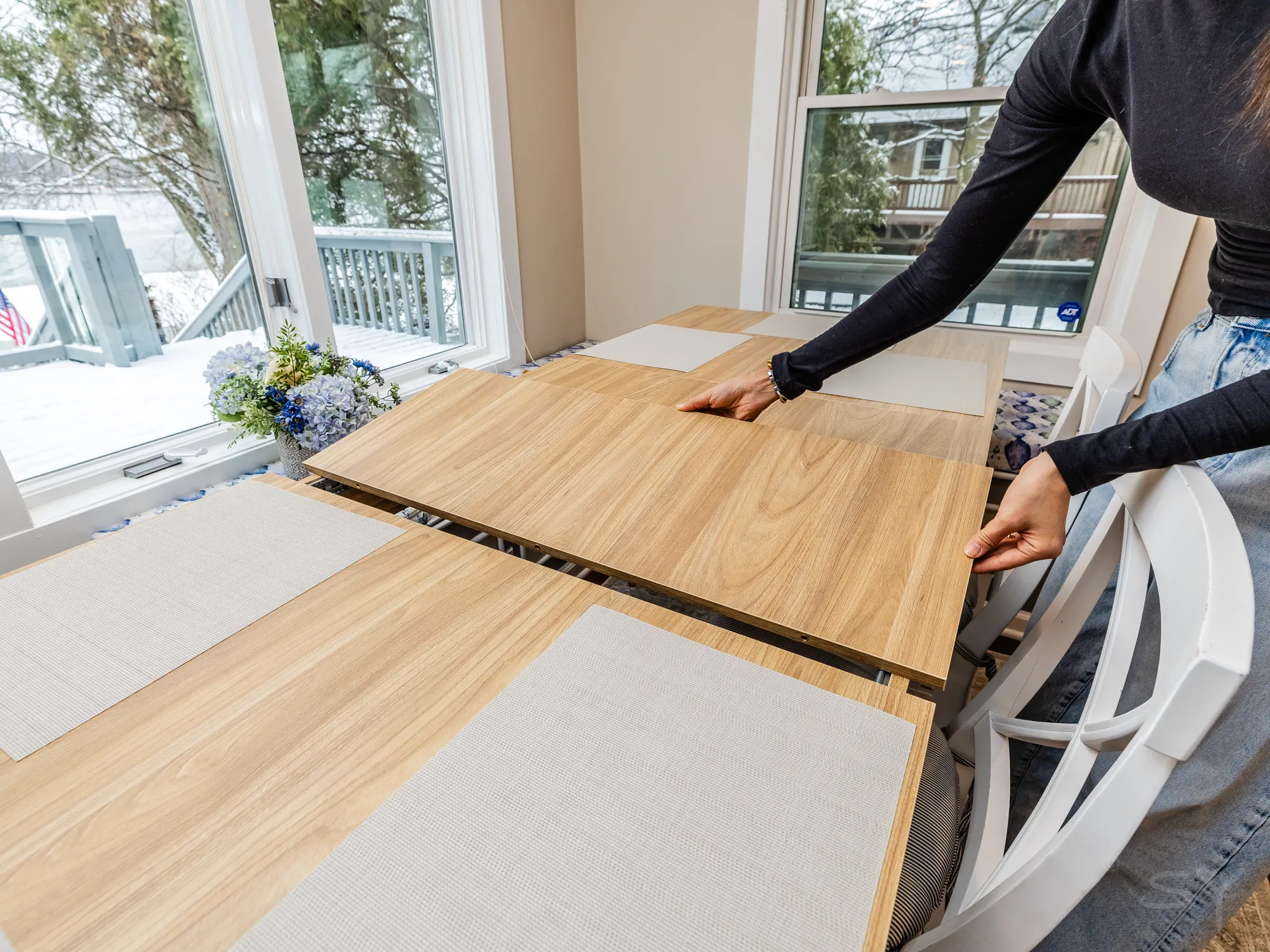 Extending the leaf of the dining table by the windows
