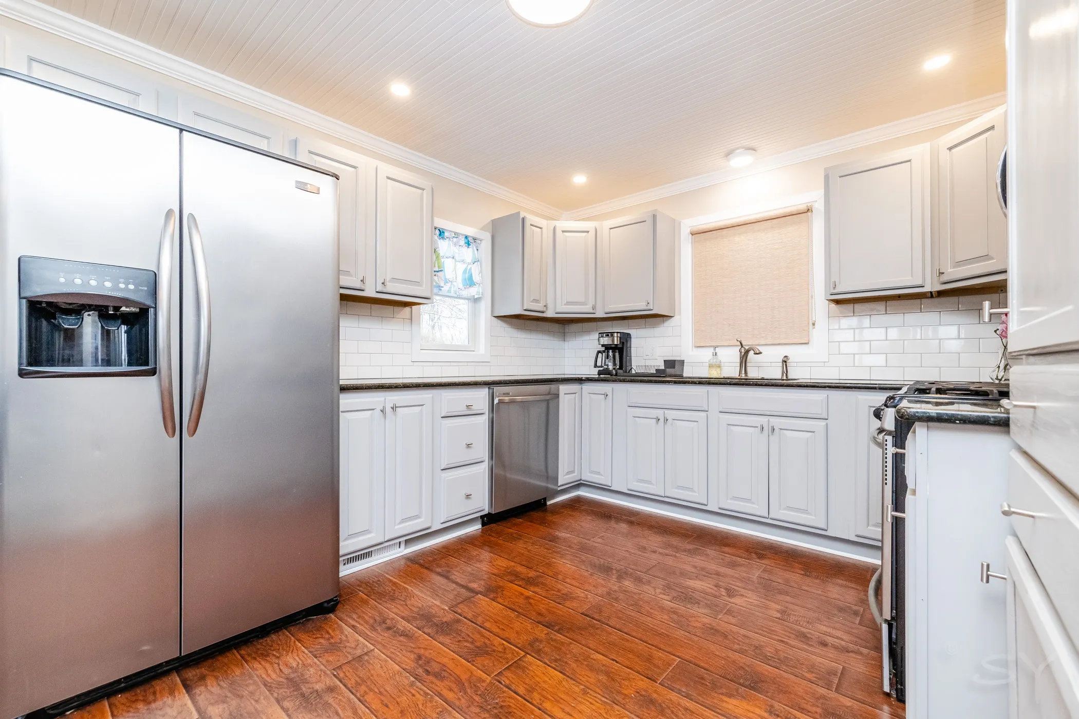 Kitchen with a stainless refrigerator, sink and cabinetry