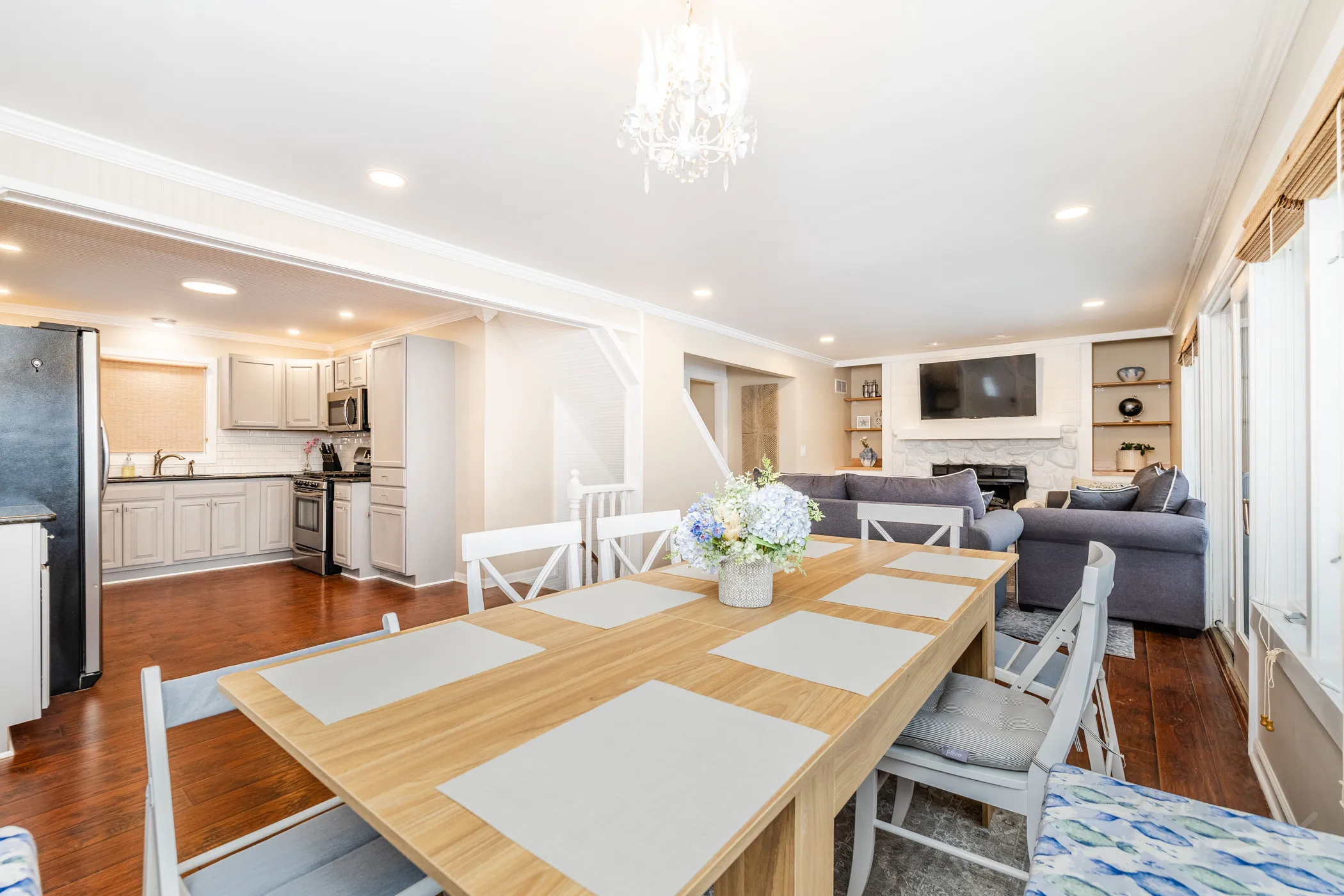 Open-plan kitchen, dining and living area with the fireplace beyond