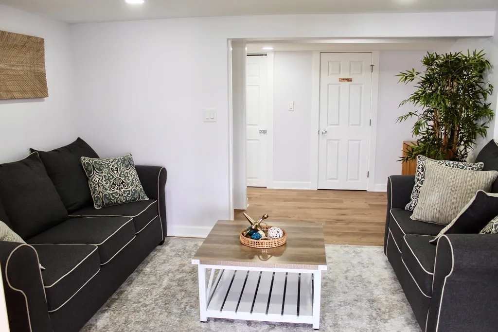Lower-level family room with two charcoal sofas