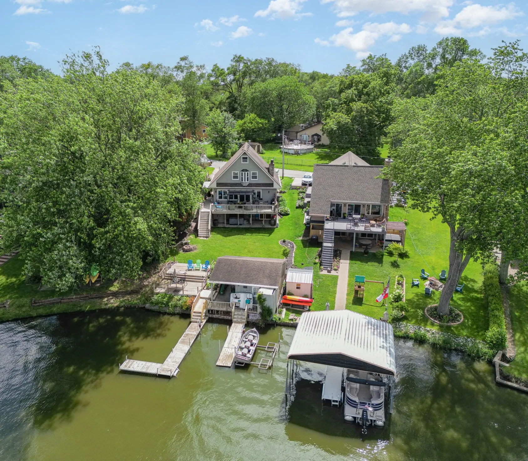 Aerial view of the lakefront property, decks and docks from above