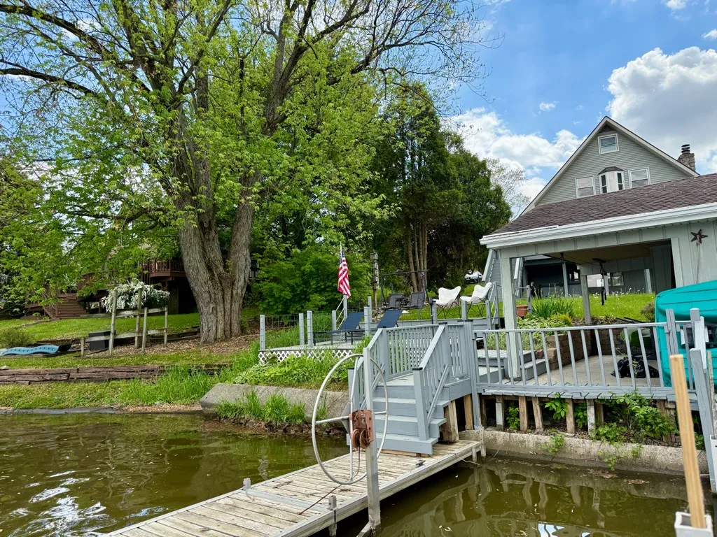View of the house and deck from the dock on the lake