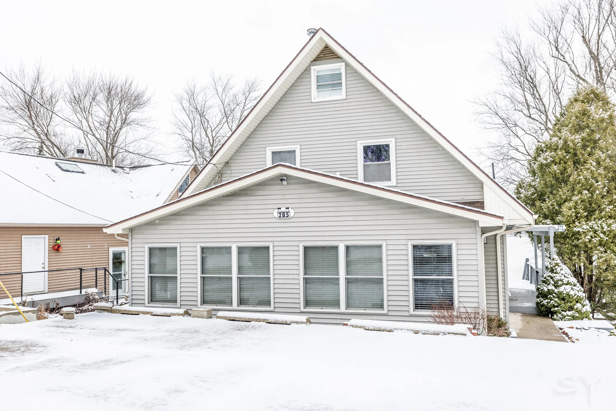 Front exterior of the lake house in winter snow